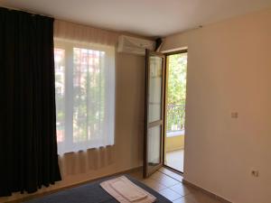 a room with a door and a window and a mirror at PS Summer Dreams Apartments in Sunny Beach