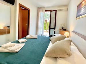 a large bed with two beds in a room at Hotel Sikania in San Vito lo Capo