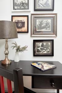 a desk with a lamp and pictures on the wall at Tamarisk Bed & Breakfast in Durban