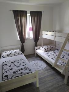 a bedroom with two bunk beds and a window at Holiday Home Racic in Bihać +26 photos
