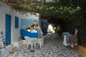 a patio with a table and chairs and an archway at Miltiadis Apartments in Ambelas