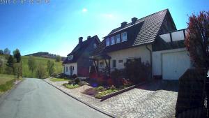 une maison sur le côté d'une route dans l'établissement Panoramablick Ferienwohnung Luge Winterberg Sauerland, à Winterberg