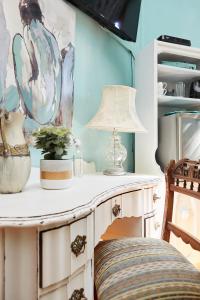 a table with a lamp on top of it in a room at Tamarisk Bed & Breakfast in Durban