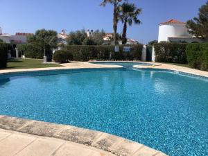 a large swimming pool with blue water at FONOLL MARÍ in Cala en Forcat