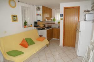 cocina con sofá amarillo en una habitación en Ferienwohnung in Sabunike mit Terrasse, Klimaanlage, W-LAN (231-2), en Privlaka