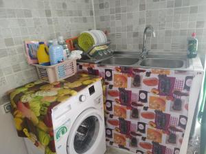 - un lave-linge dans la cuisine équipée d'un évier dans l'établissement La casita, à Vejer de la Frontera