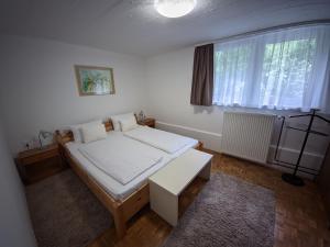 a bedroom with a large bed and a window at Szarvaskő Vendégház in Szarvaskő