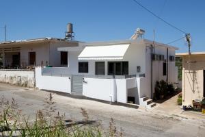 a white house on the side of a road at Villagio House in Falasarna