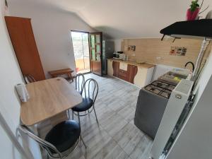 a kitchen with a counter and a table and chairs at TEI House in Năvodari