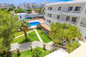 an aerial view of a building with a swimming pool at Aeolos Bay Tinos in Tinos