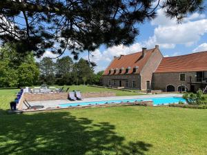 a swimming pool in a yard next to a building at CHAPEAUVEAU Gîte - b&b - Events in Helecine