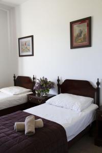 two beds in a room with white walls at Kantonia in Bobolice
