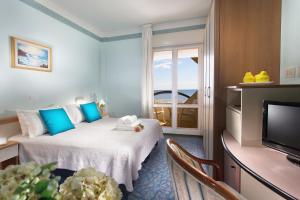 a hotel room with a bed and a television at Hotel San Pietro in Cesenatico +27 photos