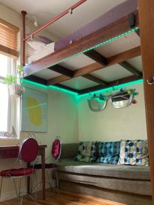 a room with a couch and glasses on the ceiling at Two Top Central Unique Artisan Beach Studios - also separate spa cabin in Brighton & Hove