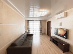 a living room with a couch and a flat screen tv at 2-bedroom apartment Most City Area, Ekaterynoslav square in Dnipro