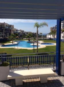 a view of a swimming pool from a balcony at Penthouse - Atico Playa Cabria Almunecar in Granada