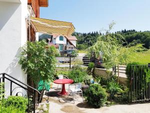a patio with a table and chairs and a house at Villa Sun Valley in Bakuriani