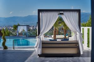 a bedroom with a canopy bed next to a pool at Villa Lumiere in Skopje