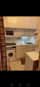 a small kitchen with a sink and a microwave at Iago lodge azur, 5 minutes à pied de la plage in Fréjus