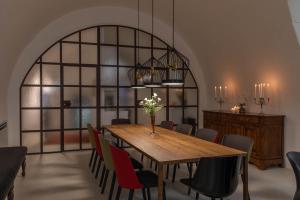 a dining room with a wooden table and chairs at Il Sogno delle Benedettine in Ostuni