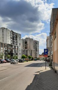 an empty street in a city with tall buildings at NINA Studio Apartment in Bijeljina