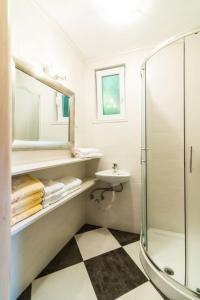 a bathroom with a shower and a sink and a mirror at Bungalow Leo (123-11) in Savudrija