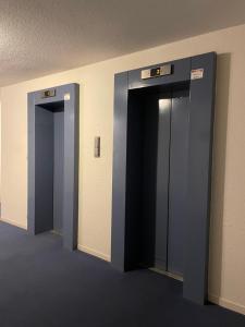 two elevator stalls in a room with two doors at studio la grande roue VUE MAGNIFIQUE in Cap d'Agde