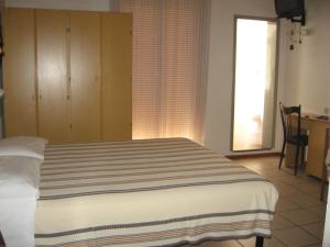 Postel nebo postele na pokoji v ubytování Hotel Eleonora