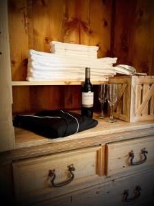 a wooden chest with a bottle of wine and two glasses at The Snowed Inn in Killington