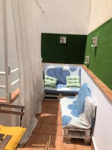 Pokój z 2 łóżkami i zieloną ścianą w obiekcie Ílios Apartamentos w Maladze