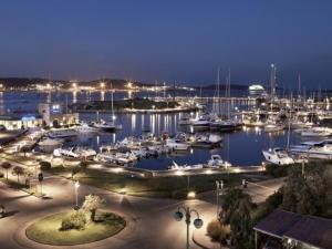 a marina at night with boats in the water at CASA WELA OLBIA in Olbia