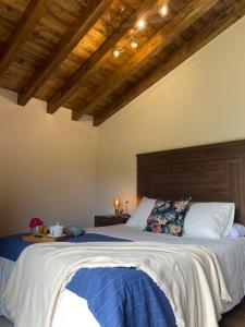 a bedroom with a large bed and wooden ceilings at Vivienda Vacacional Del Busto - Ribadesella in Ribadesella