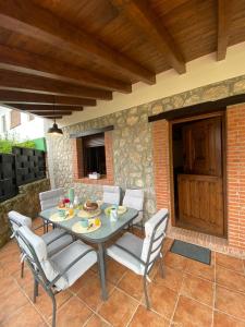 a patio with a table and chairs on a patio at Vivienda Vacacional Del Busto - Ribadesella in Ribadesella