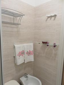 a bathroom with a toilet and a sink and towels at Stella del Mare in Sottomarina +56 photos