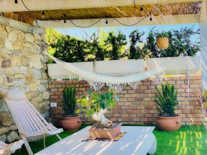 a patio with a hammock and a table and chairs at Residenza B&B VistaMare in Petacciato