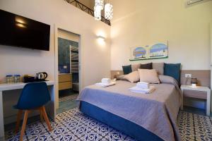 Säng eller sängar i ett rum på Antica Residenza Amalfitana