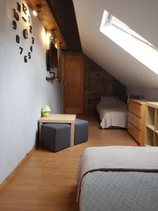 a attic room with two beds and a table at Na Stawach in Stryszów