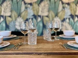 a wooden table with glasses of wine on it at Bed & Breakfast Karakter in Den Dungen