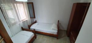 a small room with two beds and a window at Seaview apartment in Borsh