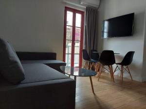 a living room with a couch and a table at Ermoupolis hidden gems in Ermoupoli