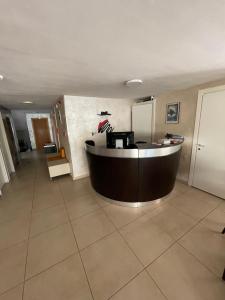 a lobby with a reception desk in a building at Fellini Rimini in Rimini