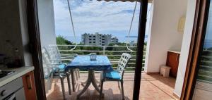 a table and chairs on a balcony with a view at Seaview apartment in Borsh