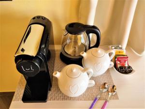 a table with a juicer and tea set on it at B&B Il Germoglio in Castione Andevenno