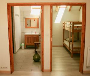 a hallway with a room with bunk beds and a sink at grande Cahute in Soultzmatt