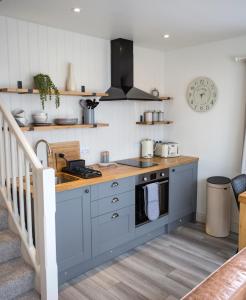 a kitchen with a sink and a stove top oven at Cruinn Bheinn Luxury Self Catering Apartments in Portree