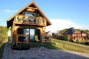 a small house with a gambrel roof at Bajkowy domek in Lubin +13 photos