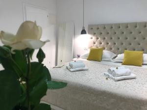 a bedroom with a large bed with yellow and white pillows at Central Park Residence in Split