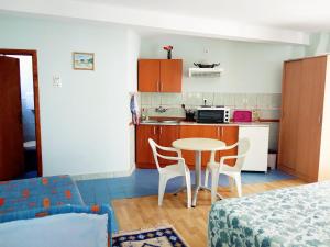 a kitchen and a table and chairs in a room at Vila Umicevic in Bijela +25 photos