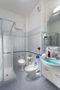 a bathroom with a toilet and a sink and a shower at Hotel San Pietro in Cesenatico