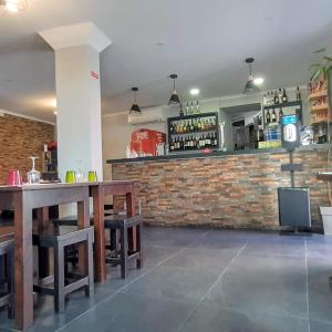 a restaurant with a bar with a brick wall at Taska Vila Velha in Mirandela